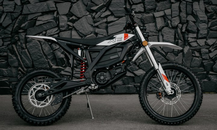 Alt text: 2025 Zero XE electric motorcycle against a rock wall.