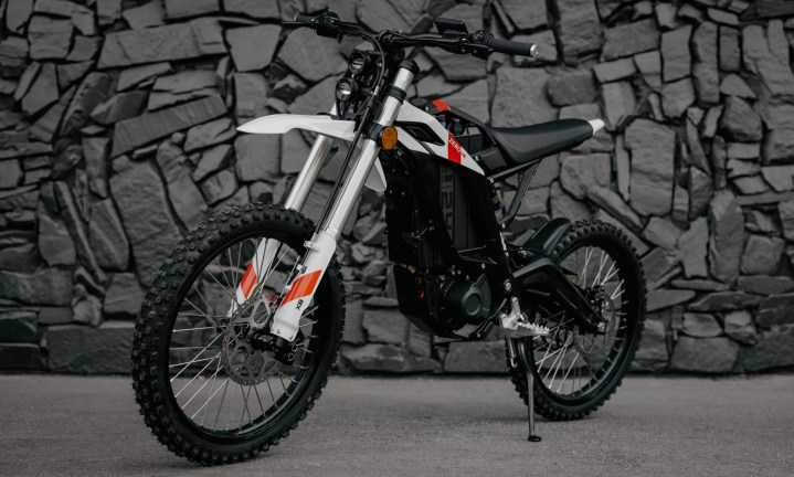 Alt text: 2025 Zero XB electric motorcycle parked against a rock wall.