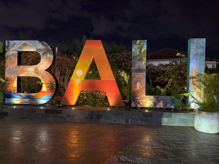 Low-light photo of the same "Bali" sign taken with the iPhone 16 Pro