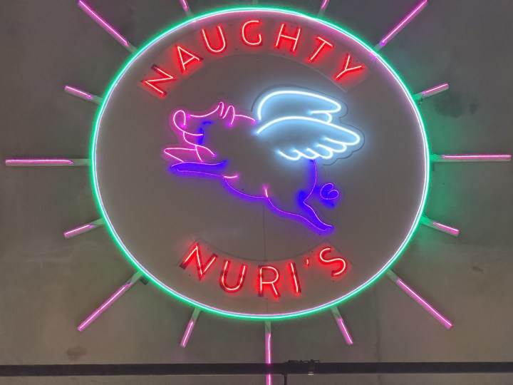 Low-light zoomed photo of the same neon sign taken with the iPhone 16 Pro