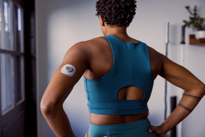 The Dexcom Stelo on the back of the arm of someone working out