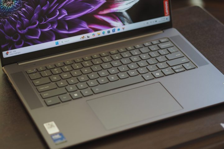 alt text: A top-down view of the Lenovo Yoga Slim 7i Aura Edition, highlighting the keyboard layout and touchpad.