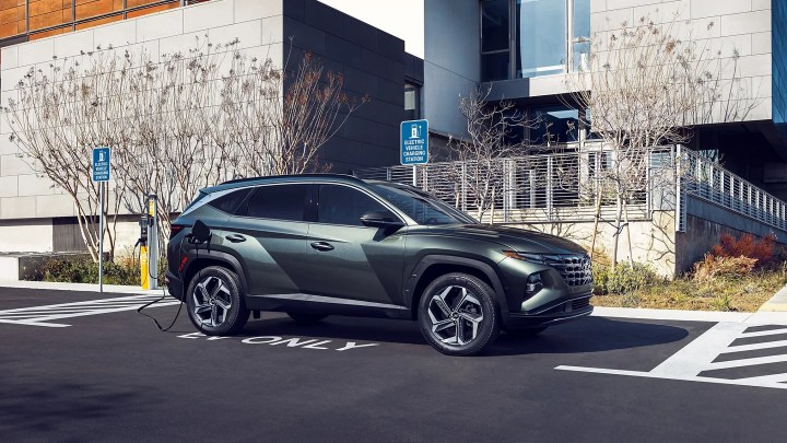 A 2022 Hyundai Tucson PHEV plugged in at a public charging station.