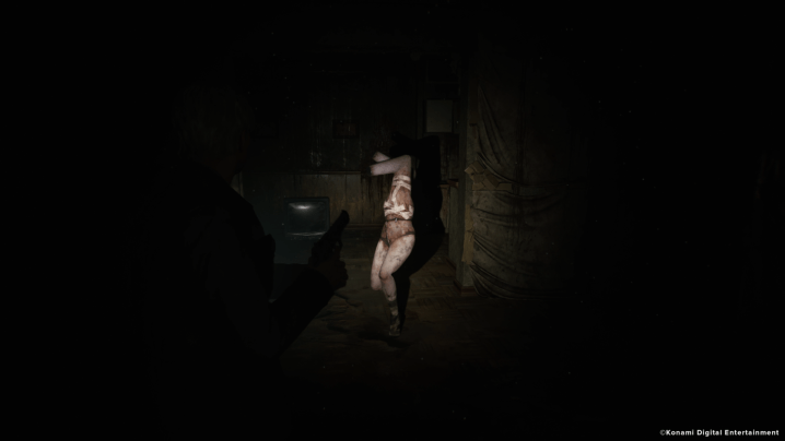 A mannequin wanders in the dark in Silent Hill 2.