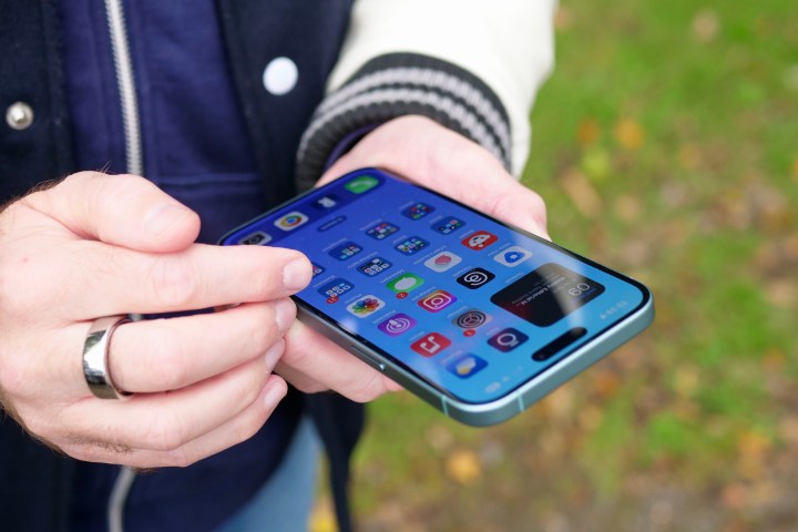 alt text: A person using the Apple iPhone 16 Plus.