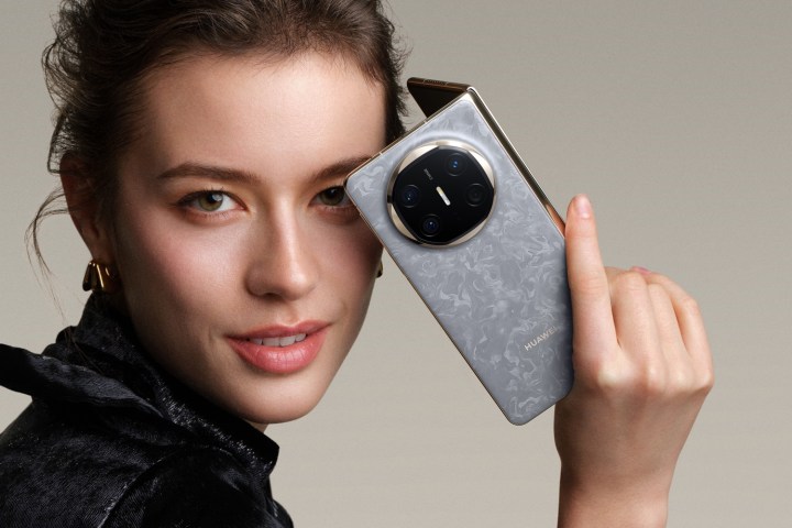 A promotional image showing a person holding the Huawei Mate X6.