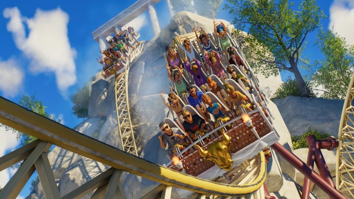 Guests riding a roller coaster in Planet Coaster 2.