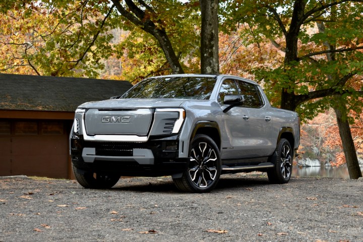 alt: Front quarter view of the 2024 GMC Sierra EV, showcasing its distinctive design and powerful presence.