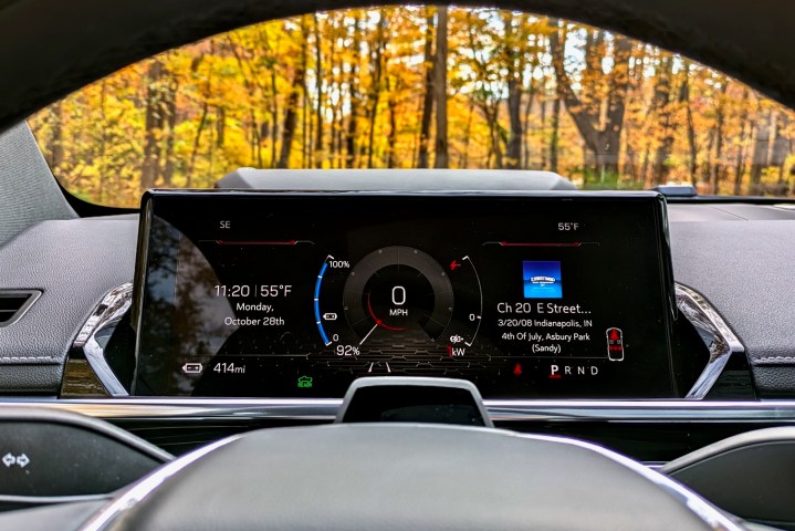 alt: Close-up of the 2024 GMC Sierra EV's digital instrument cluster displaying vehicle information and driving data.