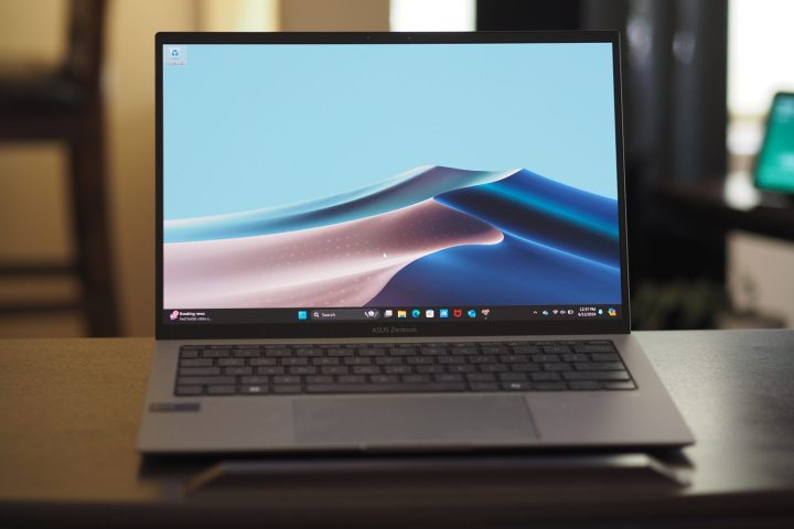 alt text:  Asus Zenbook S 13 OLED open, displaying the vibrant OLED screen and keyboard.