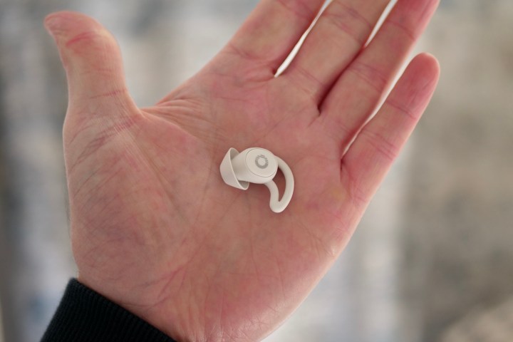 A person holding an Ozlo Sleepbuds earbud.