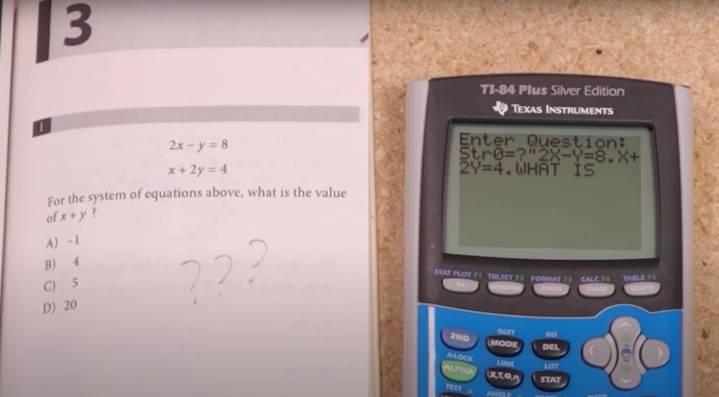 A TI-84 calculator next to a calculus textbook.