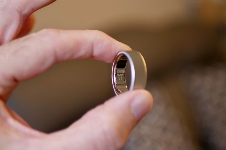 A person holding the Oura Ring 4.