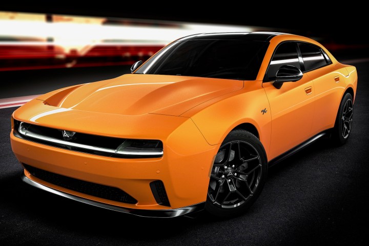 alt: Front three quarter view of a 2024 Dodge Charger Daytona sedan, showcasing its four-door design.