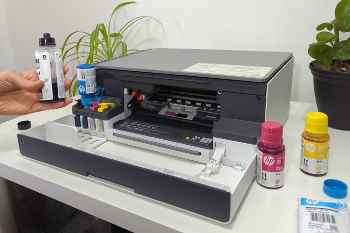 HP includes four ink bottles supplying thousands of printed pages.