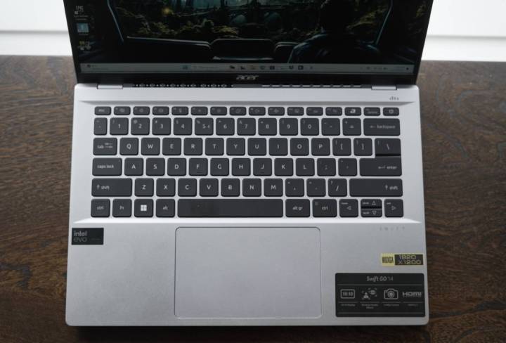 The keyboard of the Acer Swift Go 14 on a wooden table.