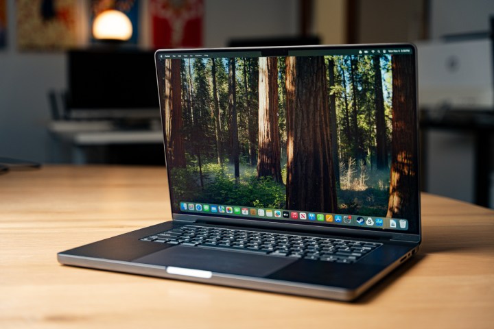 alt text: An Apple MacBook Pro 16-inch placed on a table in a brightly lit environment.