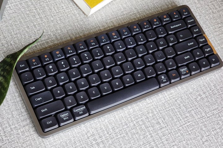 alt: Lofree Flow low-profile mechanical keyboard with black keycaps on a desk.