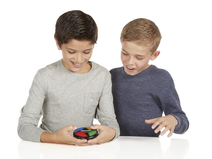 Two boys playing with a Simon Says Micro.