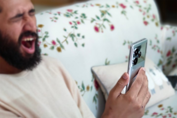 Man yawning while using the Realme GT 6.