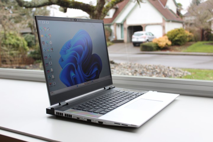 alt text: The Framework Laptop 16 positioned in front of a window, demonstrating its screen brightness and visibility.