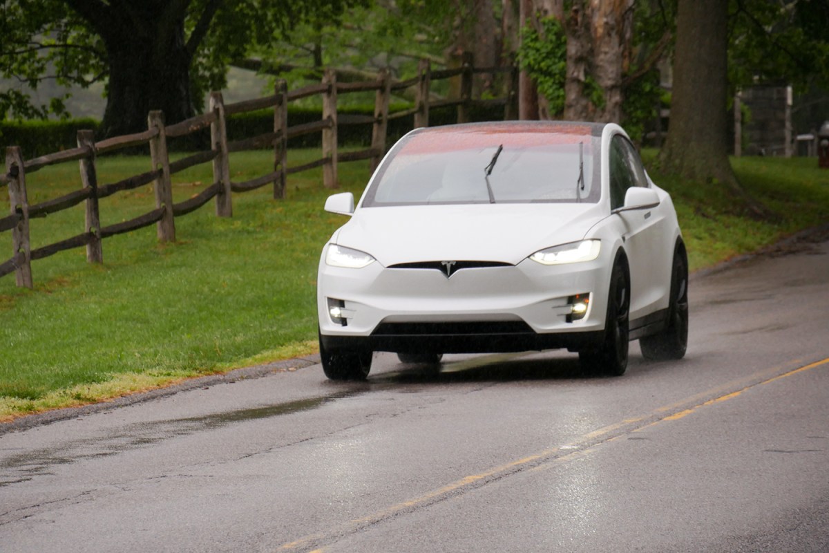 alt text focusing on the unique falcon-wing doors and performance of the Tesla Model X.