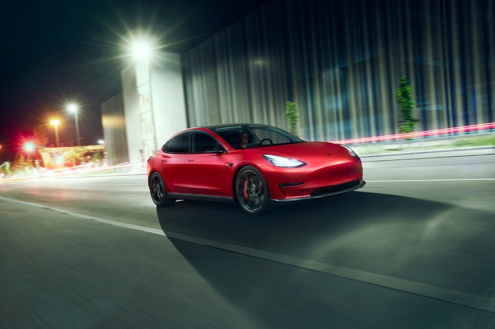 alt: A close-up of the Tesla logo on the steering wheel.