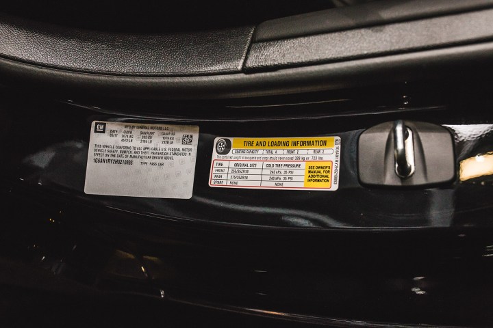 alt text: Tire pressure information sticker on a car door