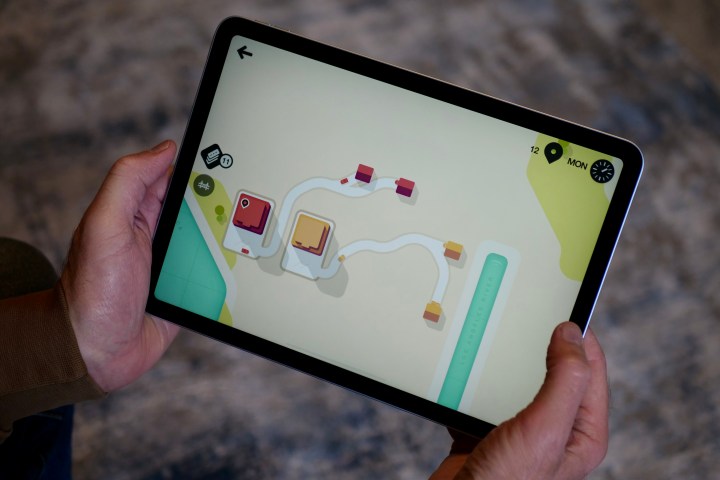 A person playing a game on the Apple iPad Air (2024).