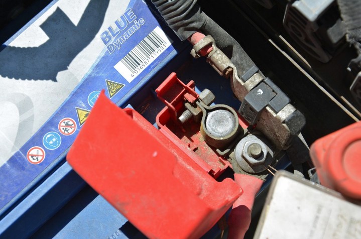 alt: A close-up of a car battery with cables attached