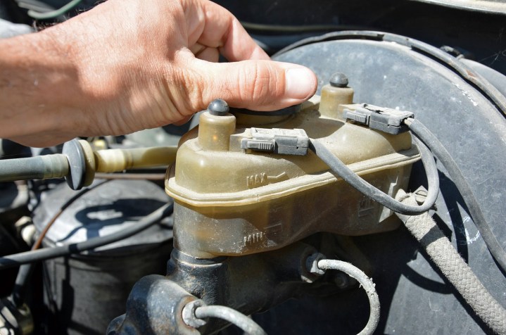 alt: A mechanic working on a car engine