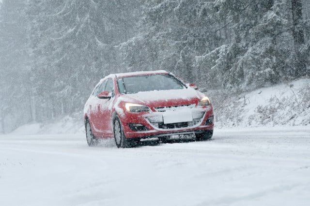 Car driving slowly in snow