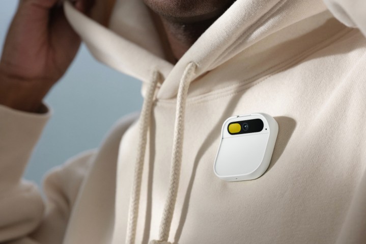 alt text: A person wearing the Humane AI Pin, demonstrating its hands-free functionality.