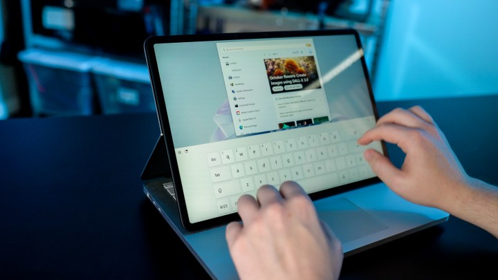 alt text: A user interacting with the Surface Laptop Studio 2 in Stage Mode.