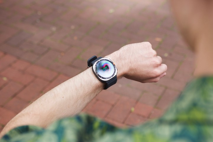 A person wearing and interacting with the Samsung Galaxy Watch Ultra.