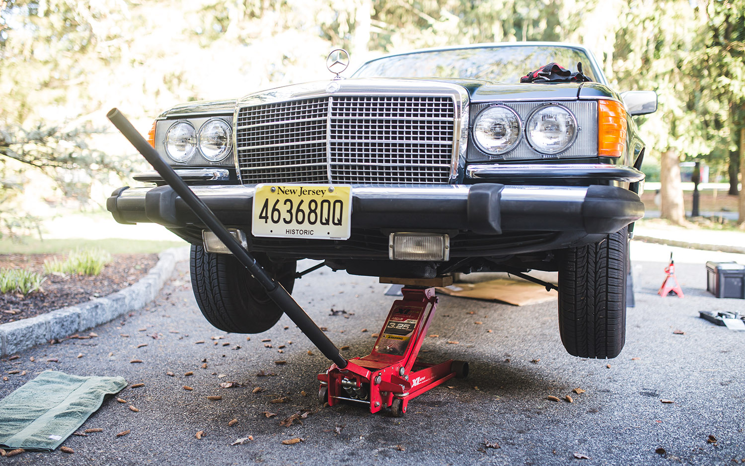 alt text: Person tightening lug nuts on a car wheel