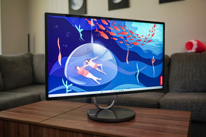 The Lenovo Yoga AIO 9i placed on a coffee table, highlighting its sleek design and overall aesthetic.