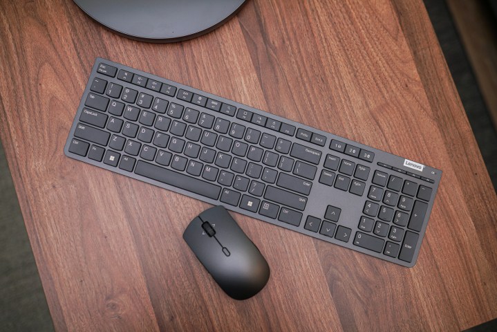 The included wireless keyboard and mouse for the Lenovo Yoga AIO 9i, showcasing the sleek design and connectivity options.