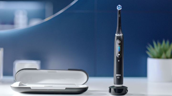 Alt: A close-up of an Oral-B iO electric toothbrush, highlighting its sleek design and advanced features.