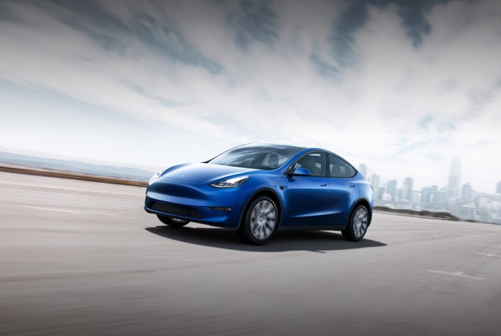 Alt: A white Tesla Model Y showcasing its sleek exterior.