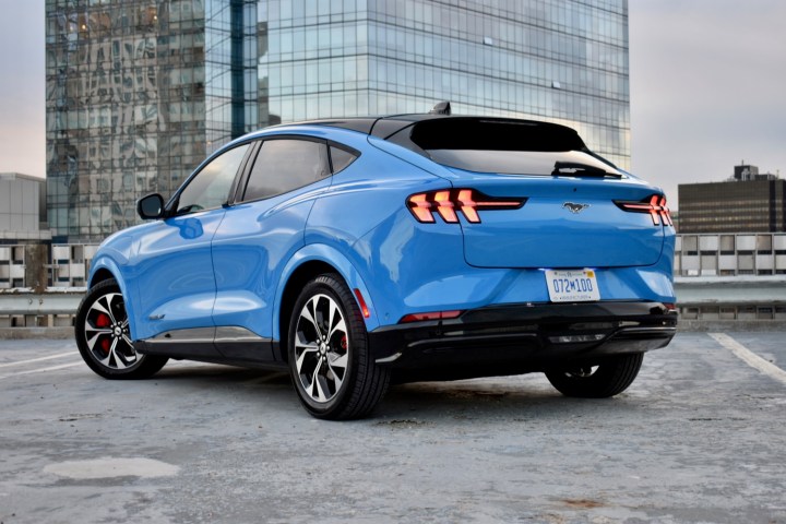 alt text: A blue Ford Mustang Mach-E showcased in a studio setting.