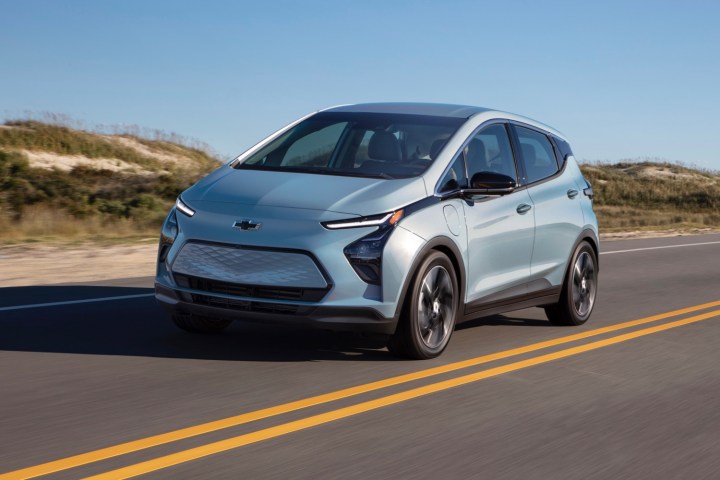 alt text: A silver Chevrolet Bolt EV parked on a city street.