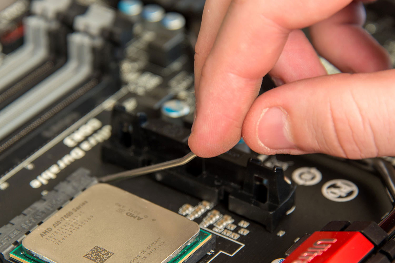 Alt: Gently placing the AMD CPU into the socket.