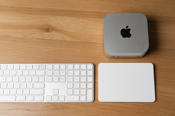 The Mac mini next to the Magic Keyboard and Magic Mouse.