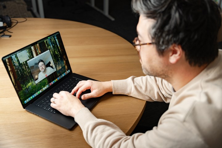 A person using the webcam on the MacBook Pro.