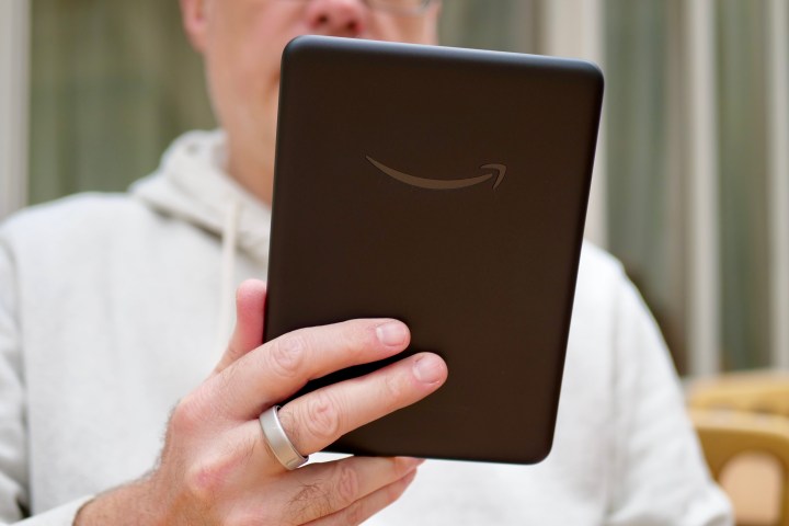 A person holding the Amazon Kindle Colorsoft Signature Edition.