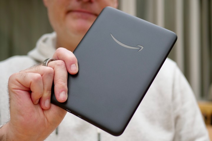 A person holding the Amazon Kindle Colorsoft Signature Edition.