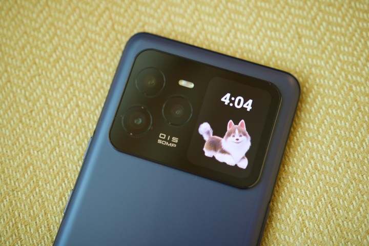 Alt: The rear screen of the Lava Agni 3 showing the time and a playful animated dog.