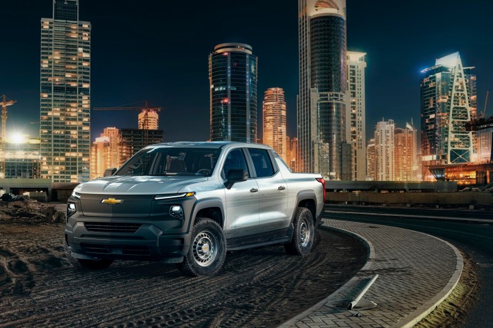 alt text: The 2024 Chevrolet Silverado EV WT pickup truck parked on a city street.