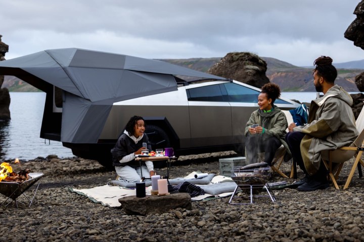 alt text: A Tesla Cybertruck with a camping setup in the truck bed, highlighting its potential for outdoor adventures.